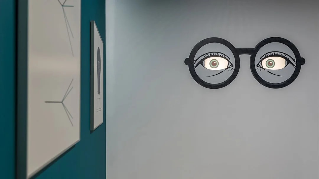 Wall art with optical illusion of eyes in glasses at Museum of Illusions, Thessaloniki.