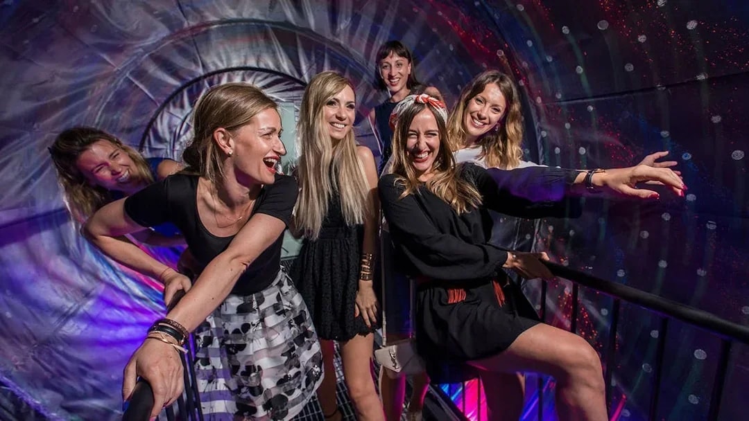 Visitors enjoying interactive exhibits at the Museum of Illusions in Vienna, Austria.