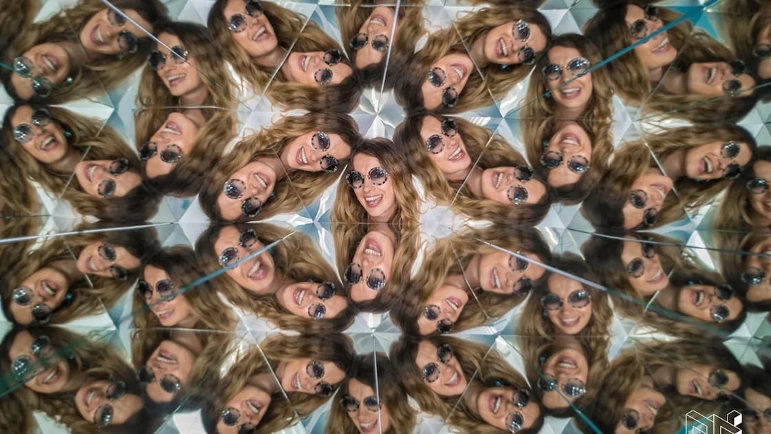 Visitors in kaleidoscope exhibit at Museum of Illusions, Vienna, Austria.