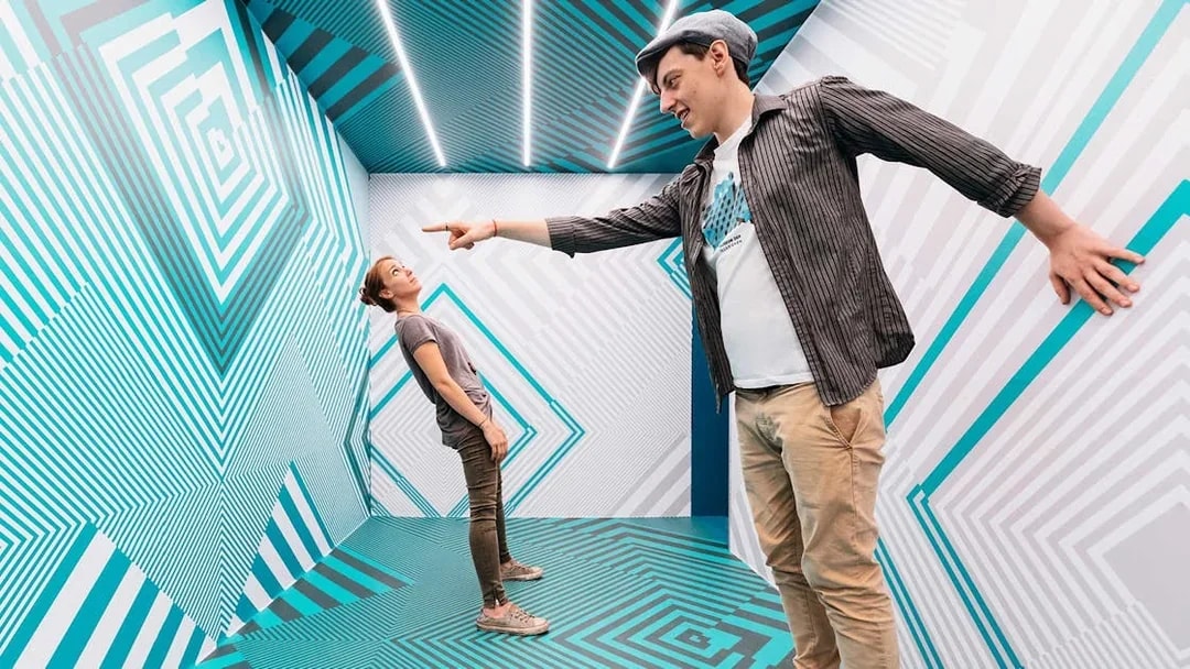 Visitors interacting in an optical illusion room at Museum of Illusions Vienna.