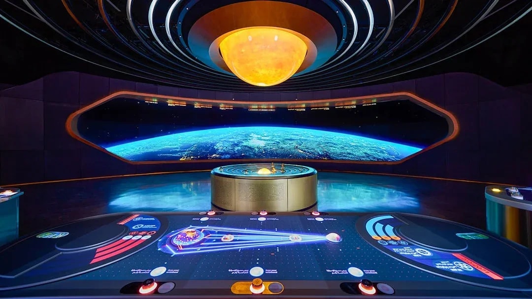 Interactive exhibit at The OSS Hope, Museum of the Future, Dubai, featuring a futuristic control panel and Earth display.
