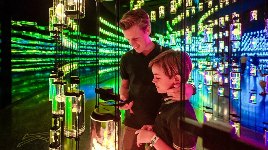 Visitors exploring interactive exhibit at Dubai's Museum of The Future with Pioneer Pass access.