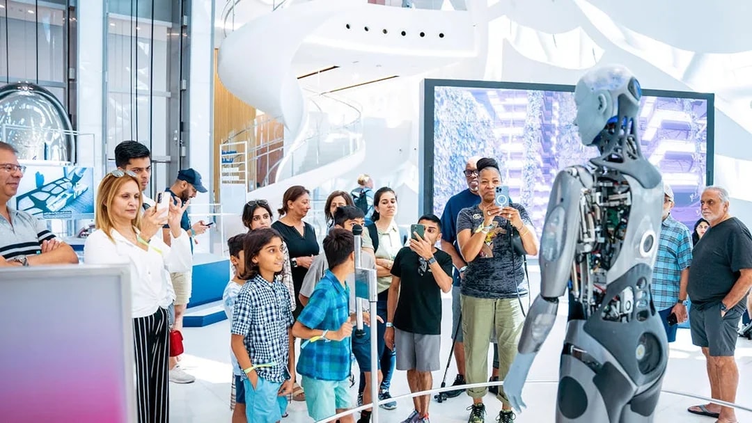 Visitors interacting with a robot at Dubai's Museum of The Future, Pioneer Pass access.