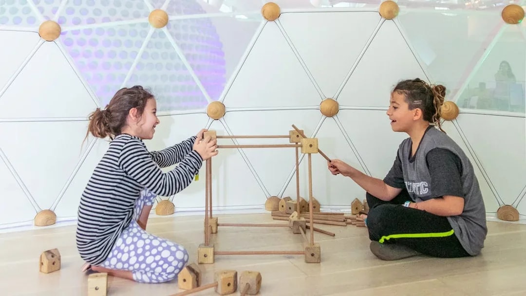 Children building with wooden blocks at Museum of The Future, Dubai.