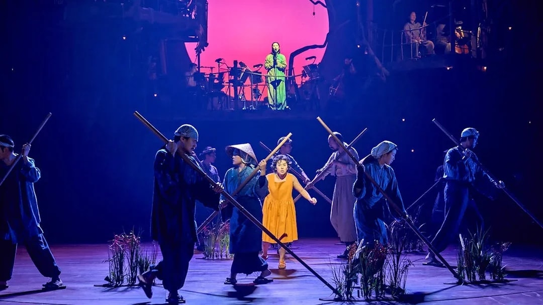 Performers on stage during My Neighbour Totoro show, with a vibrant backdrop.