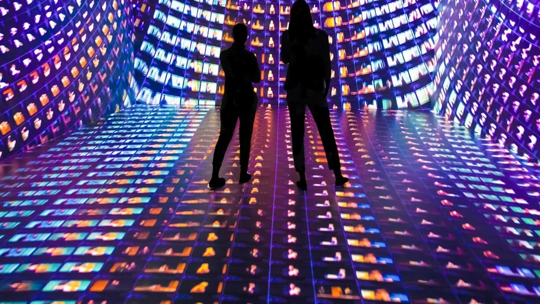 Visitors in an immersive digital art installation at Mythos Mozart exhibit.