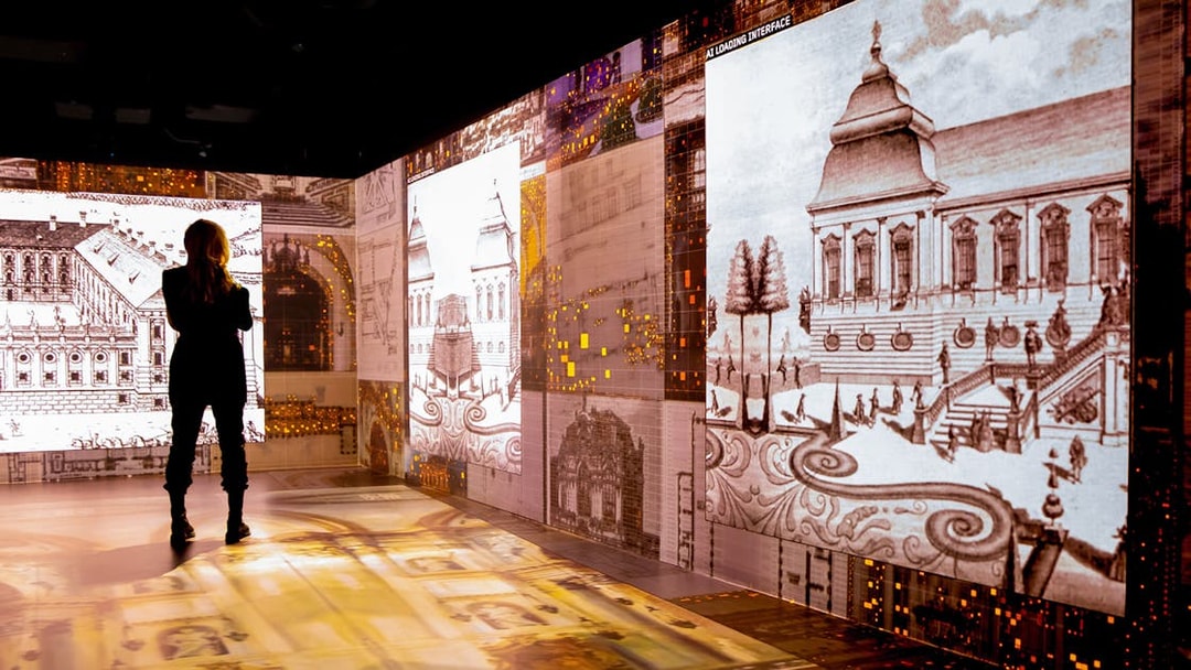 Visitor viewing digital Mozart-themed art installation in Vienna.