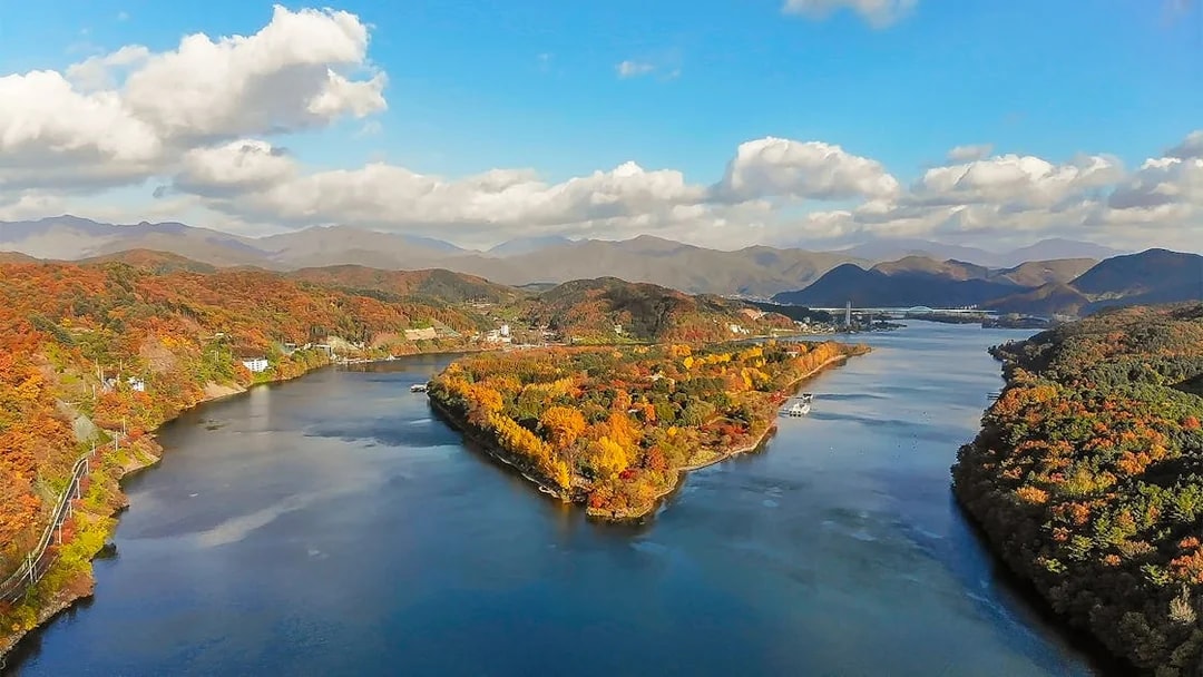 Aerial view of Nami Island in half-moon shape surrounded by autumn foliage, South Korea.