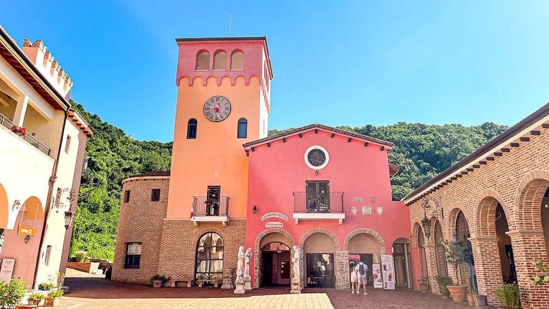 Clock tower and pink building in Italian Village Pinocchio e Da Vinci, South Korea.