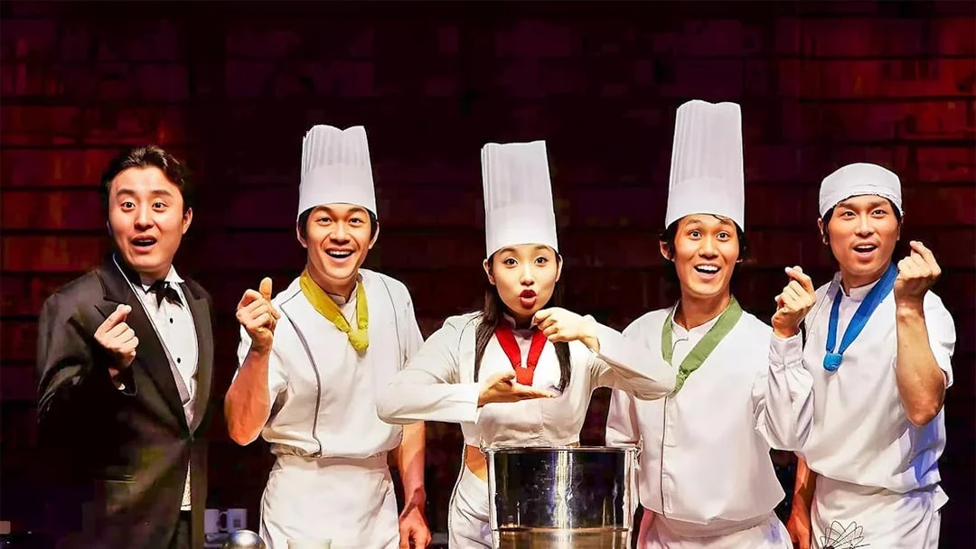 Performers in chef outfits on stage during Jeju Nanta Musical Show.