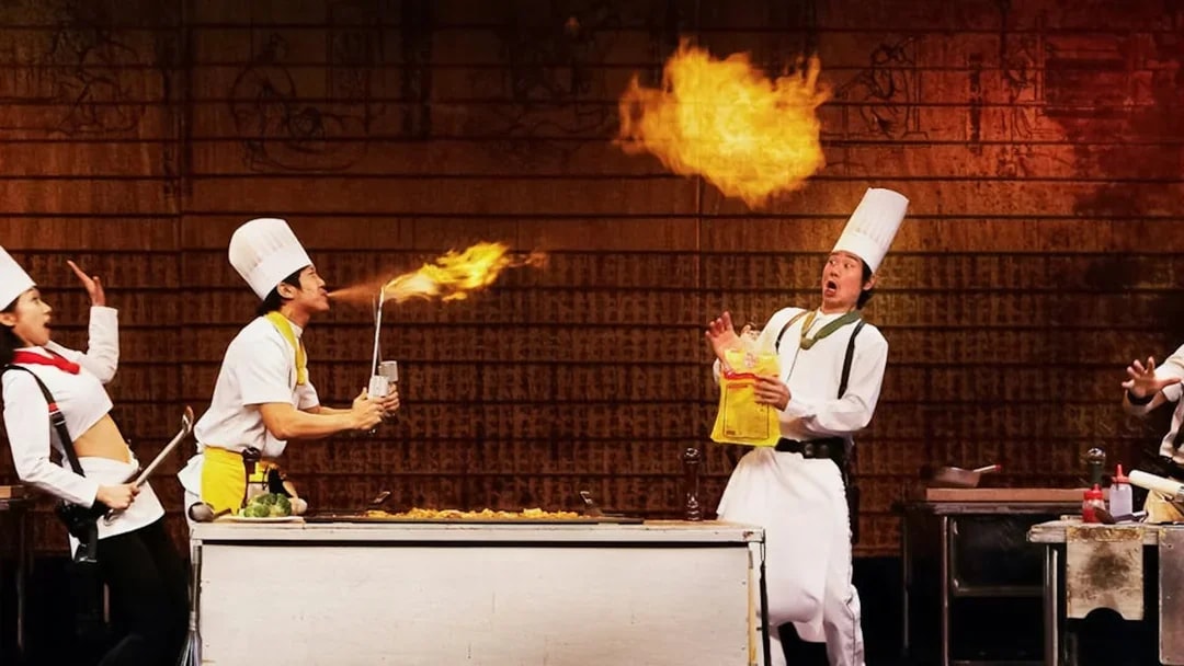 Chefs performing a comedic cooking act with fire during Seoul Night Guided Tour's Nanta show.
