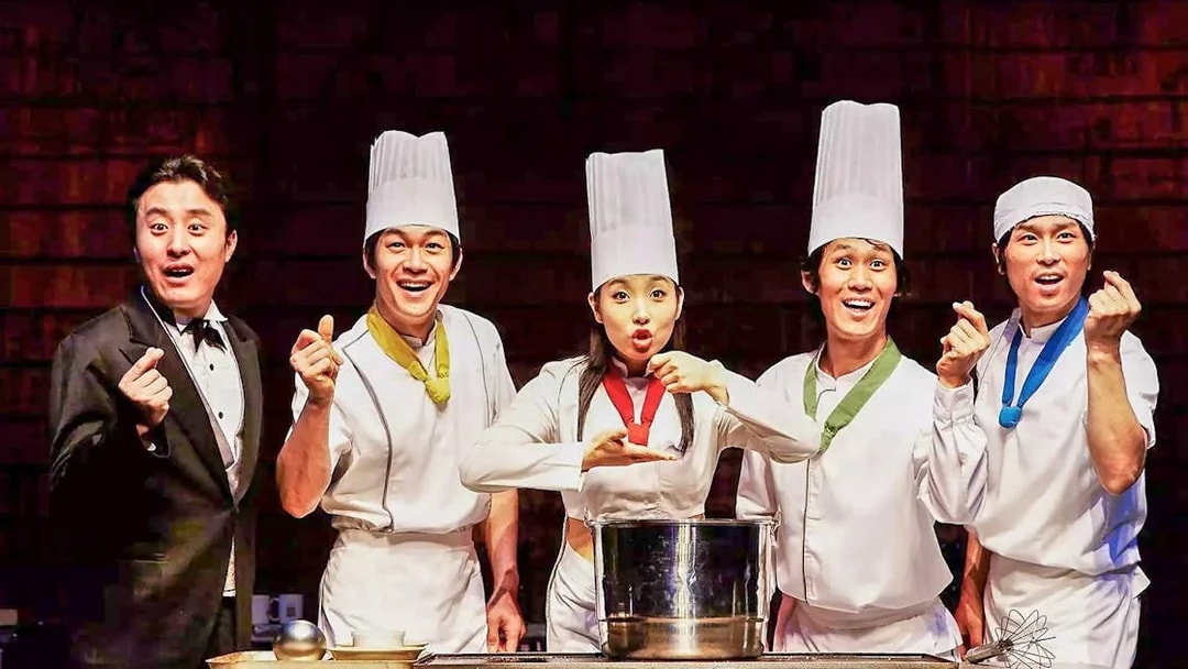 Performers in chef outfits on stage at Seoul Myeongdong Nanta Musical Show.