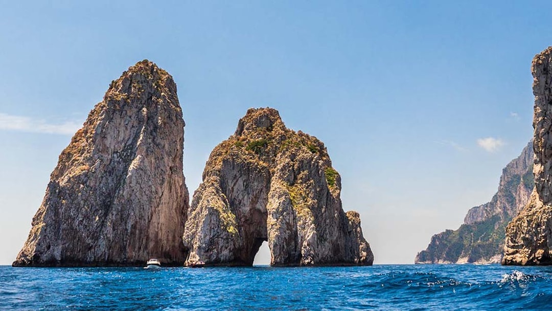Faraglioni rock formations in Capri Island, Italy, viewed from the sea.