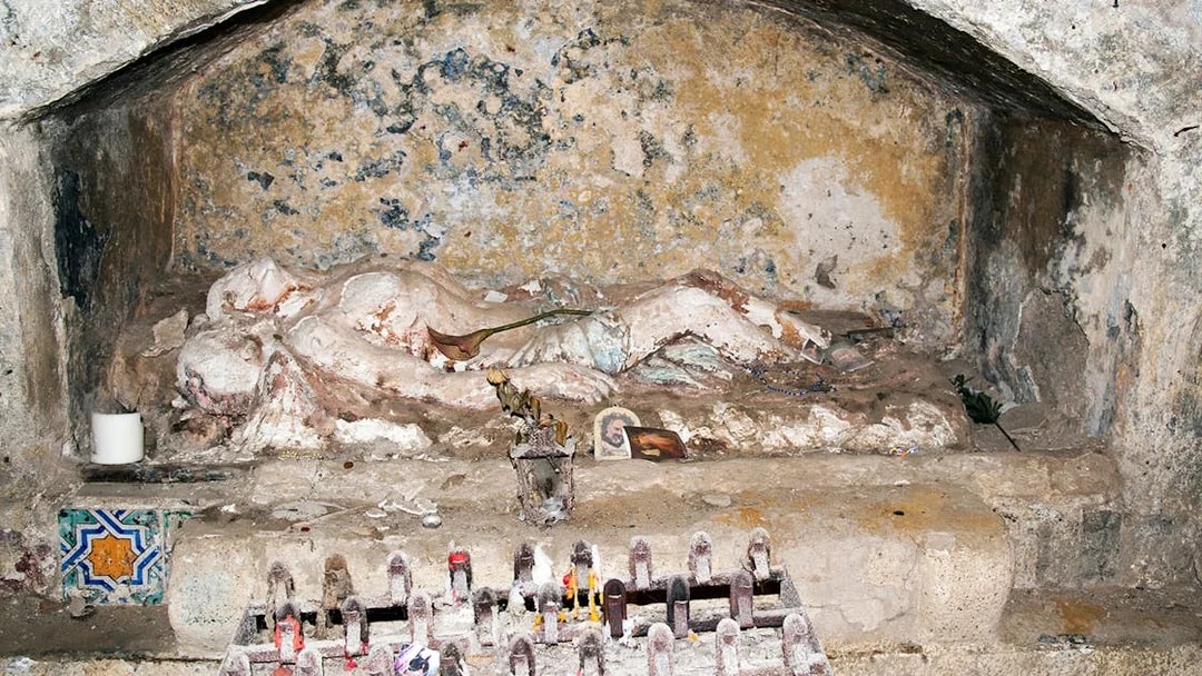 Ancient tomb with religious artifacts in Catacombs of San Gennaro, Naples.