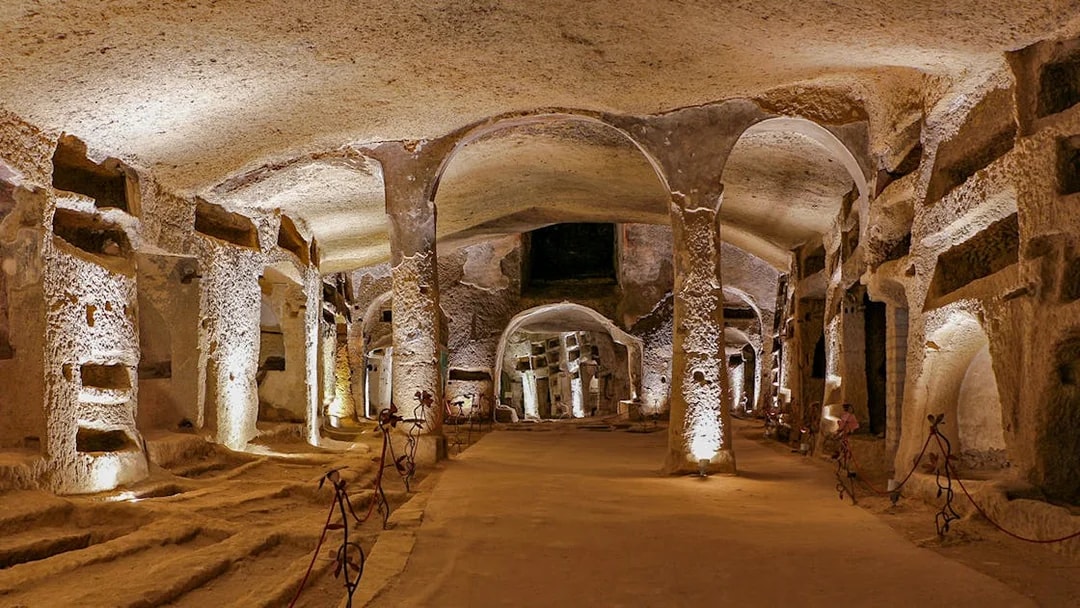 Catacombs of San Gennaro in Naples with ancient burial niches and arches.