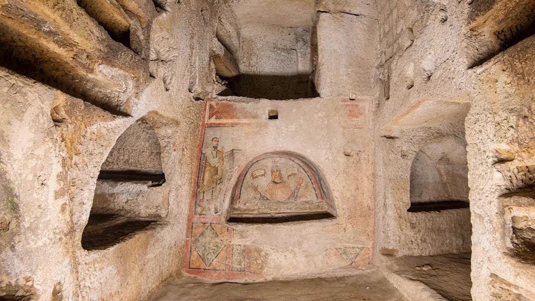 Catacombs of San Gennaro frescoes and burial niches in Naples, Italy.