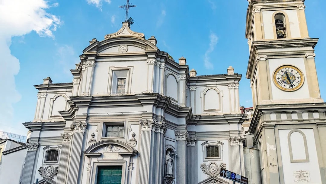 Basilica of Santa Maria della Sanita facade with clock tower in Naples, Italy.
