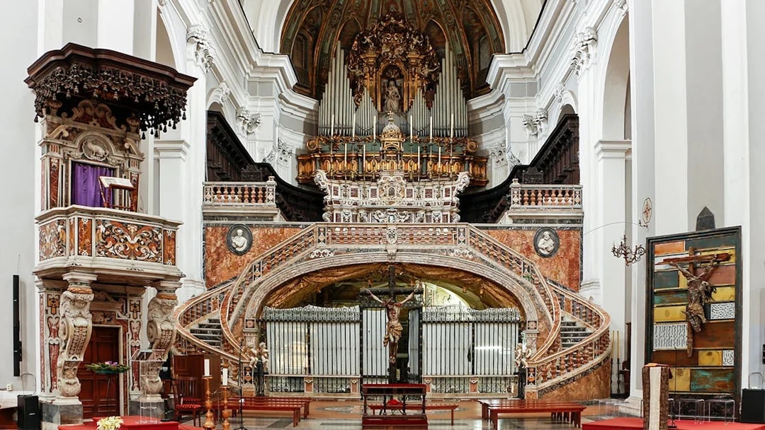 Interior of Basilica of Santa Maria della Sanita, featuring ornate altar and pulpit near Catacombs of San Gaudioso.