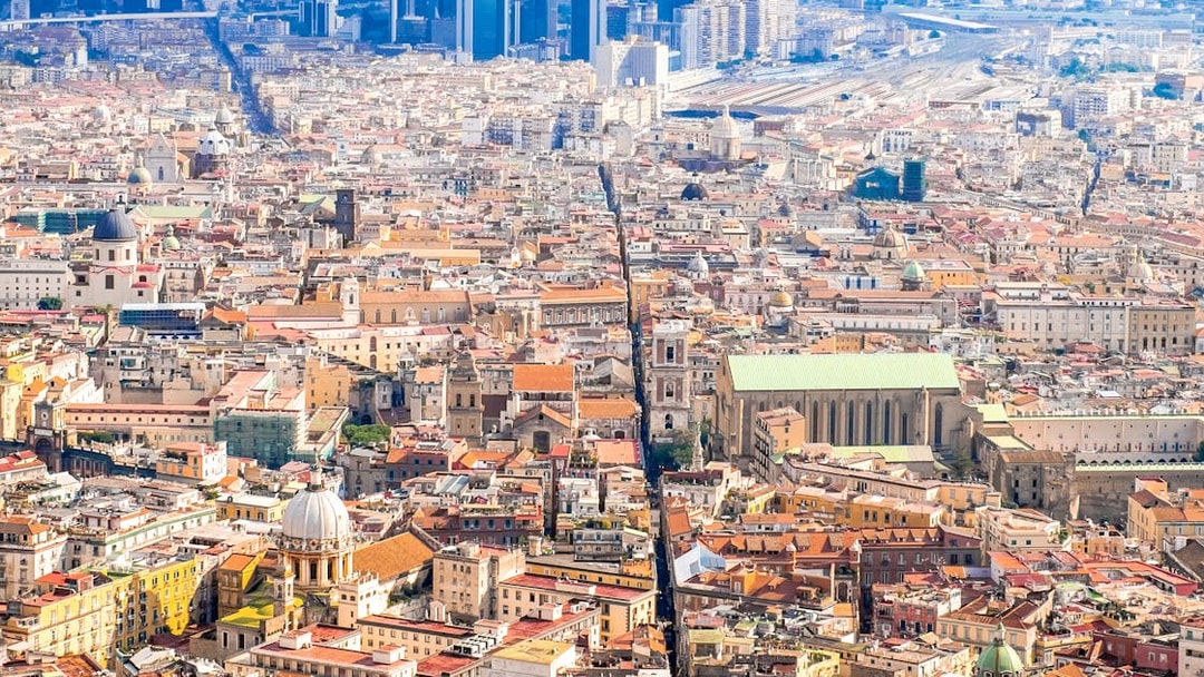 Aerial view of Naples cityscape, highlighting historic architecture and urban layout.