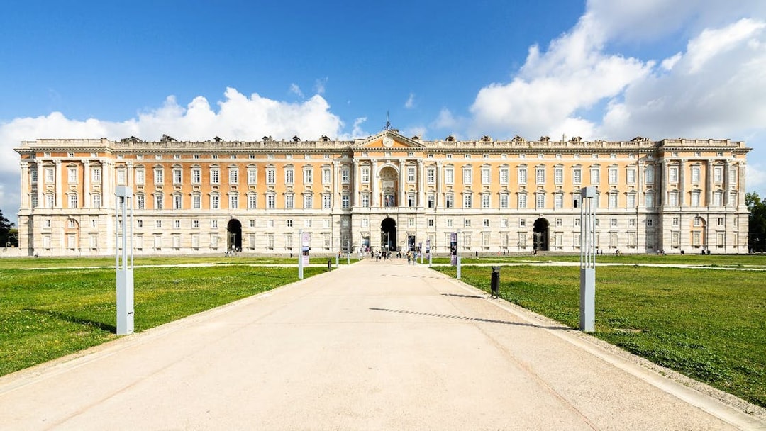 Royal Palace of Caserta facade with pathway, Naples tour destination.