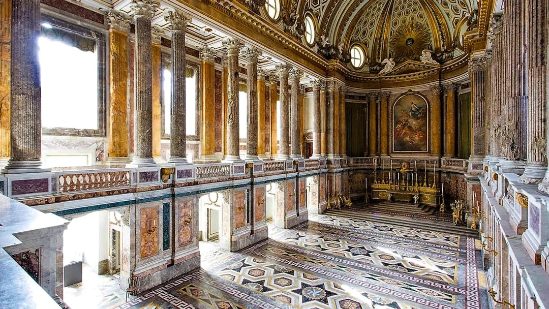 Palatine Chapel interior with ornate columns and detailed ceiling at Royal Palace of Caserta.