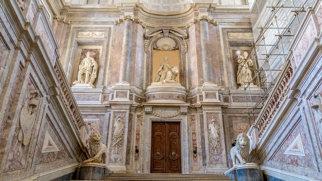 Staircase of Honour with statues and ornate architecture in the Royal Palace of Caserta.