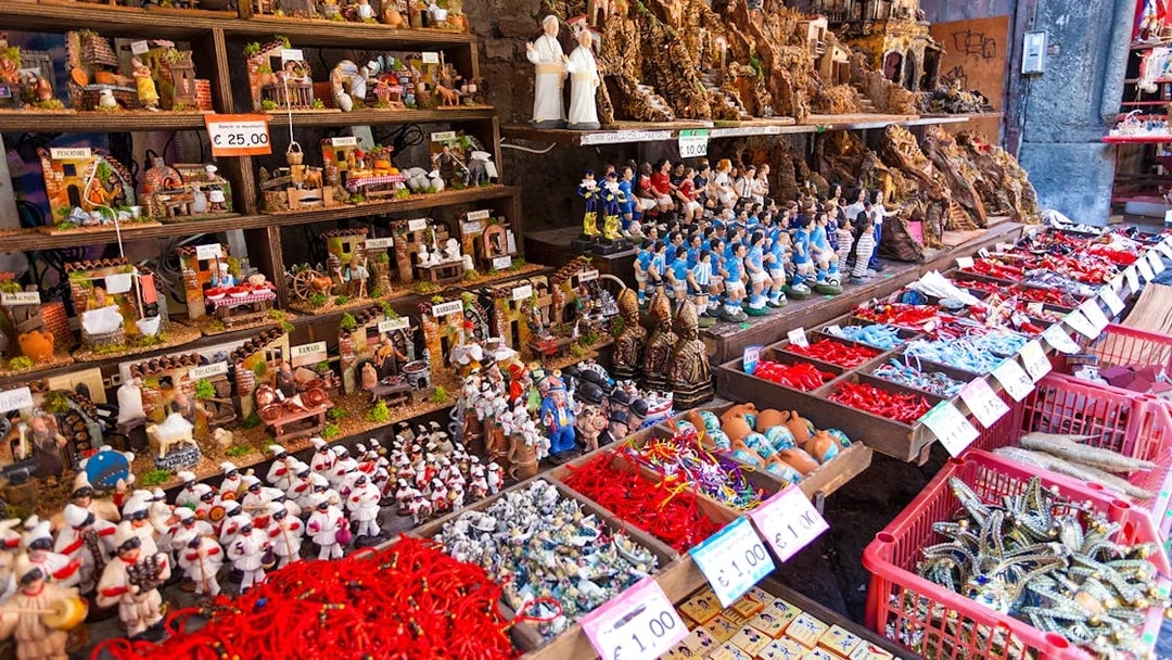 Nativity figurines and souvenirs displayed on San Gregorio Armeno street in Naples.