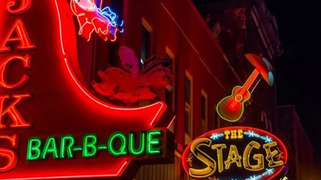 Neon signs of Jack's Bar-B-Que and The Stage on Broadway, Nashville at night.