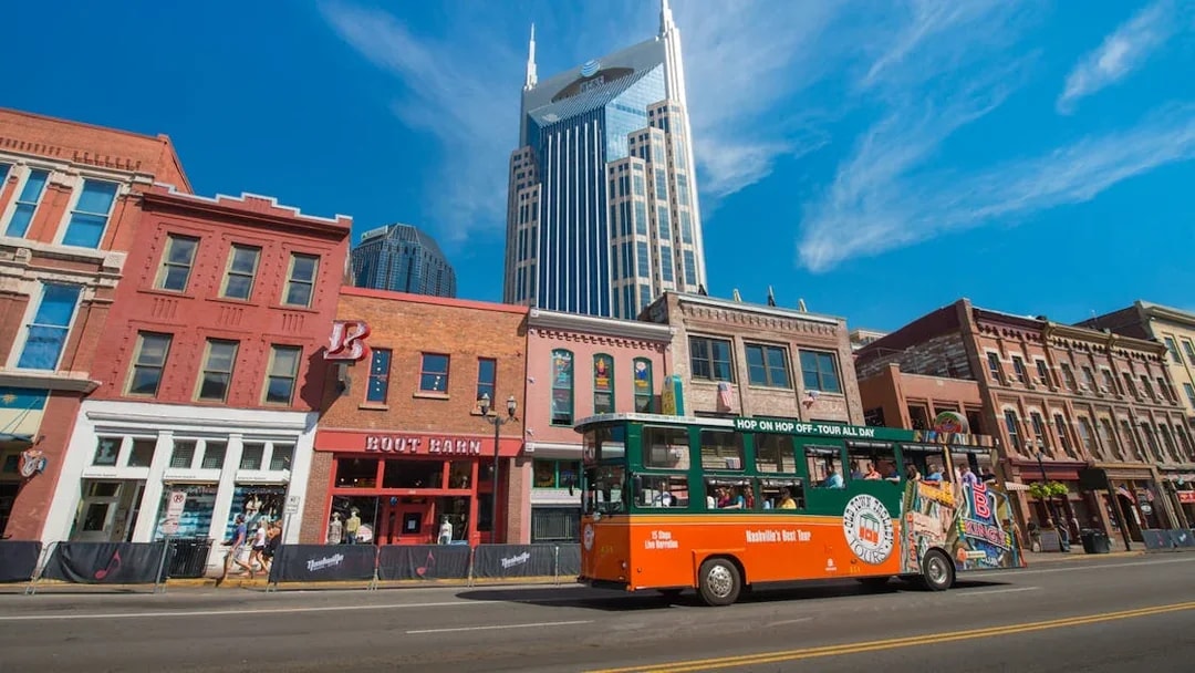 Nashville Old Town Trolley passing historic buildings with AT&T Building in background.
