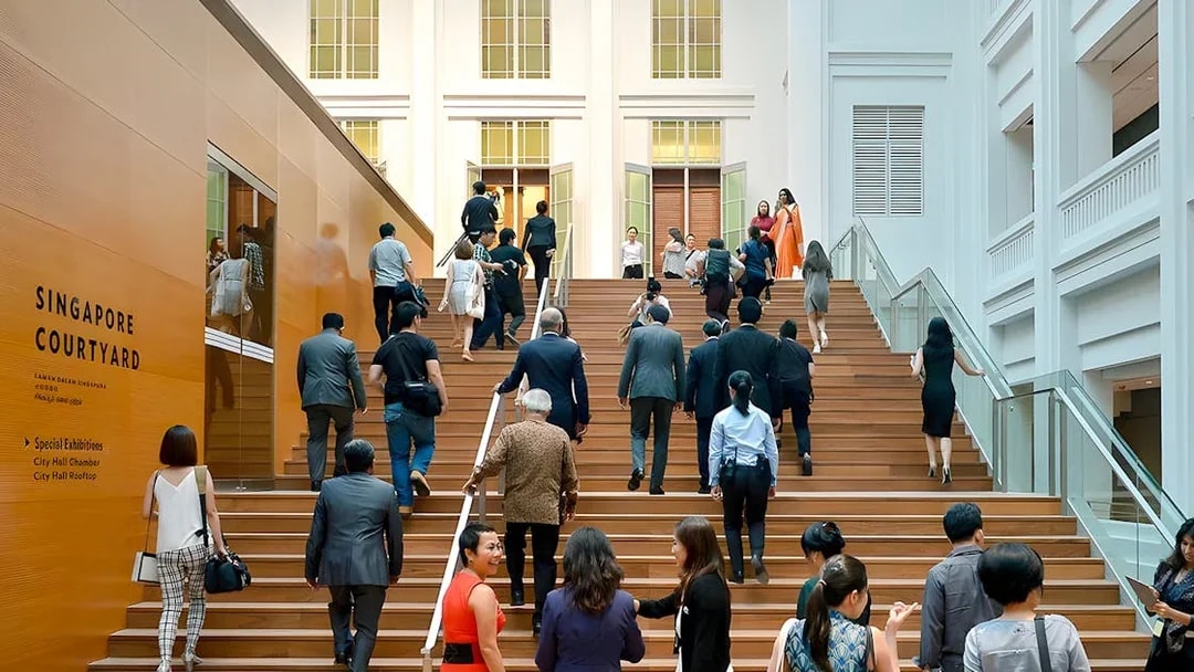 Guests ascending steps at National Gallery Singapore courtyard.