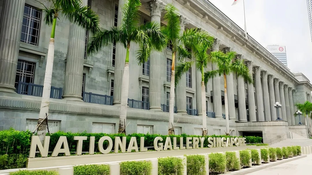 National Gallery Singapore exterior with columns and palm trees.