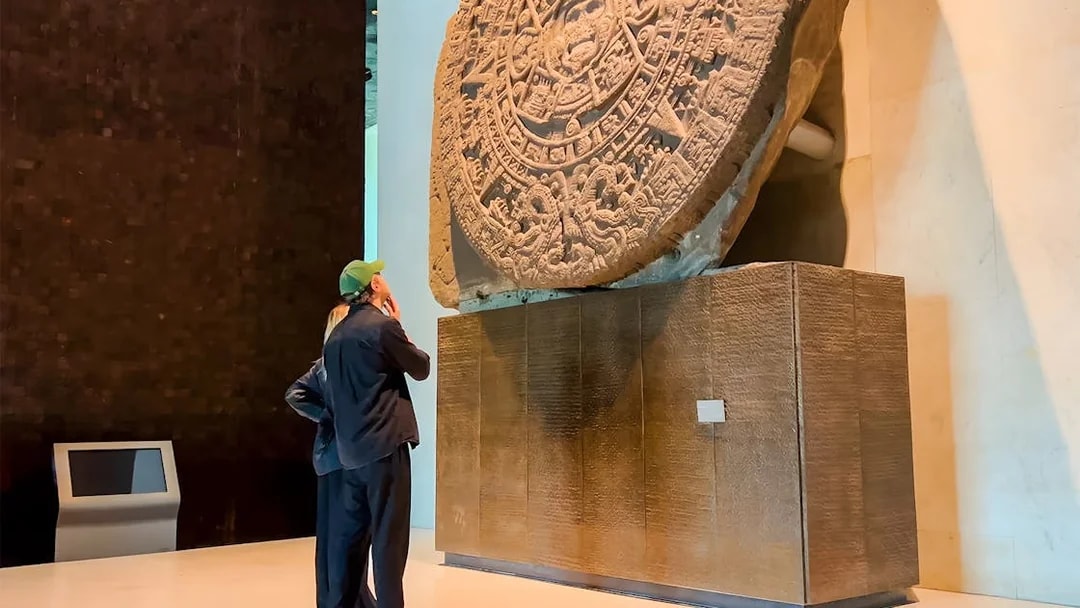 Visitors viewing the Aztec Sun Stone at the National Museum of Anthropology, Mexico City.