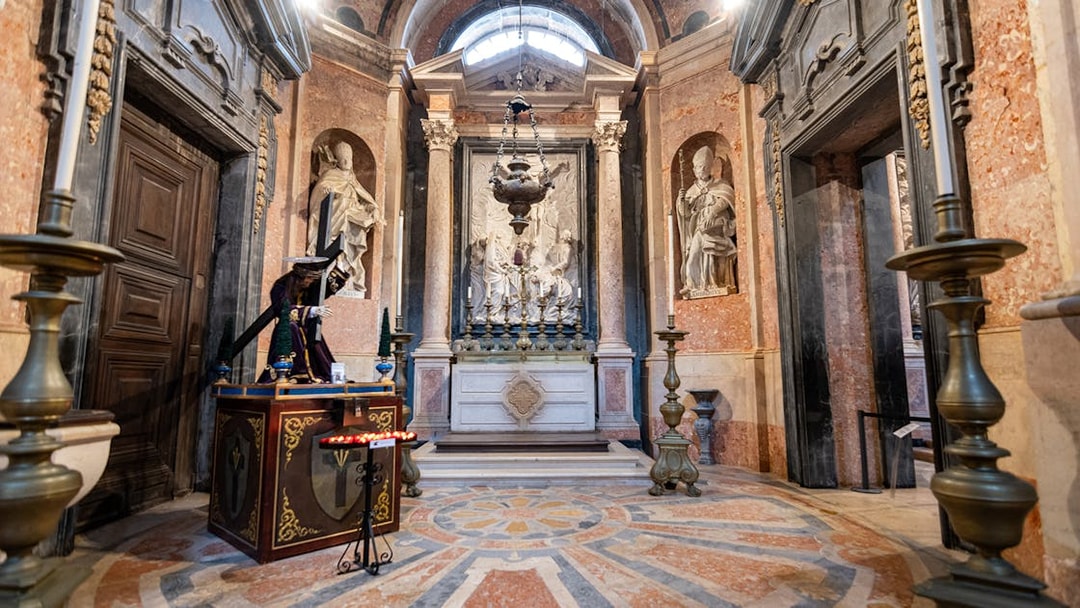 Altar inside the National Palace of Mafra with ornate sculptures and decorative elements.