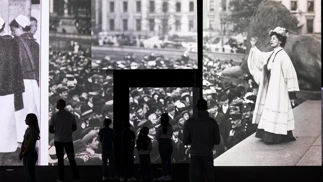 Visitors viewing historical photographs at the Frameless National Portrait Gallery Exhibition.