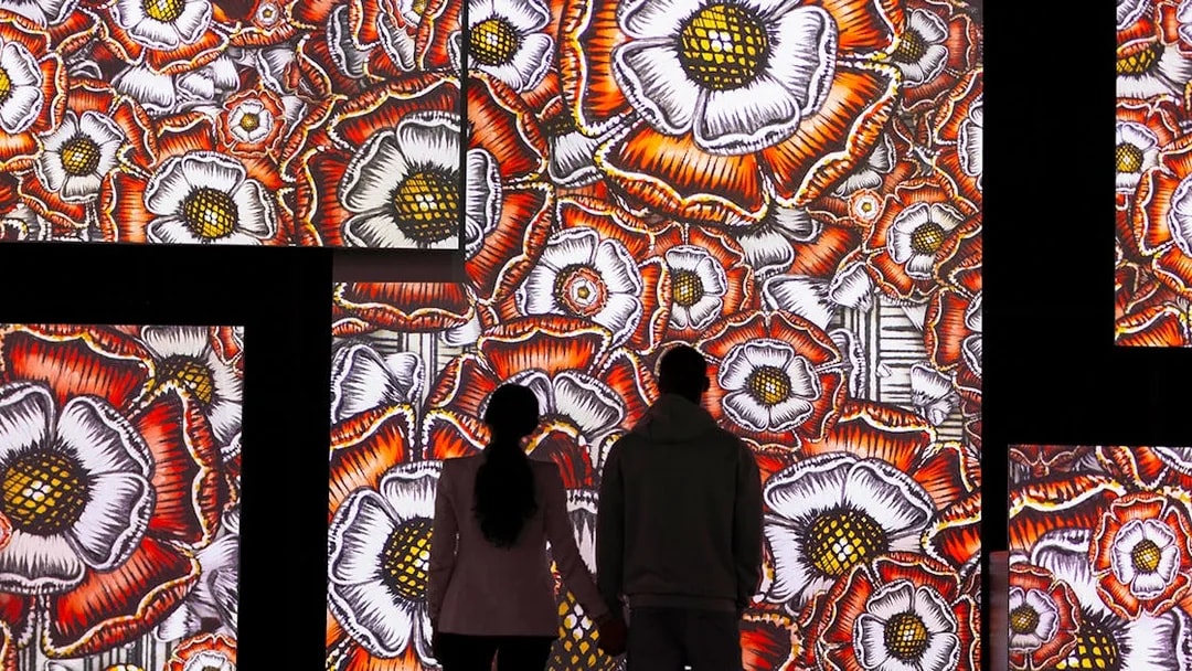 Visitors viewing floral digital art at Frameless National Portrait Gallery Exhibition.