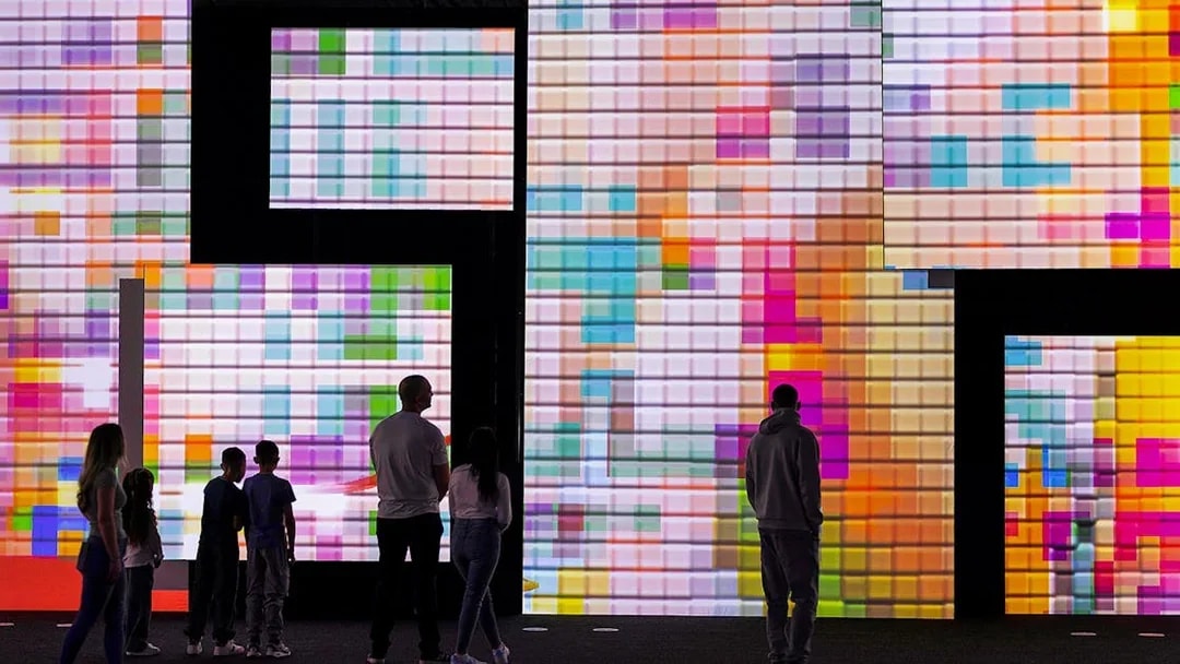 Visitors viewing digital art displays at the Frameless National Portrait Gallery Exhibition.