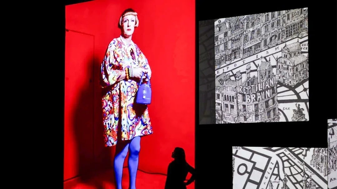 Grayson Perry artwork at Frameless National Portrait Gallery Exhibition, London, featuring colorful attire and intricate map design.