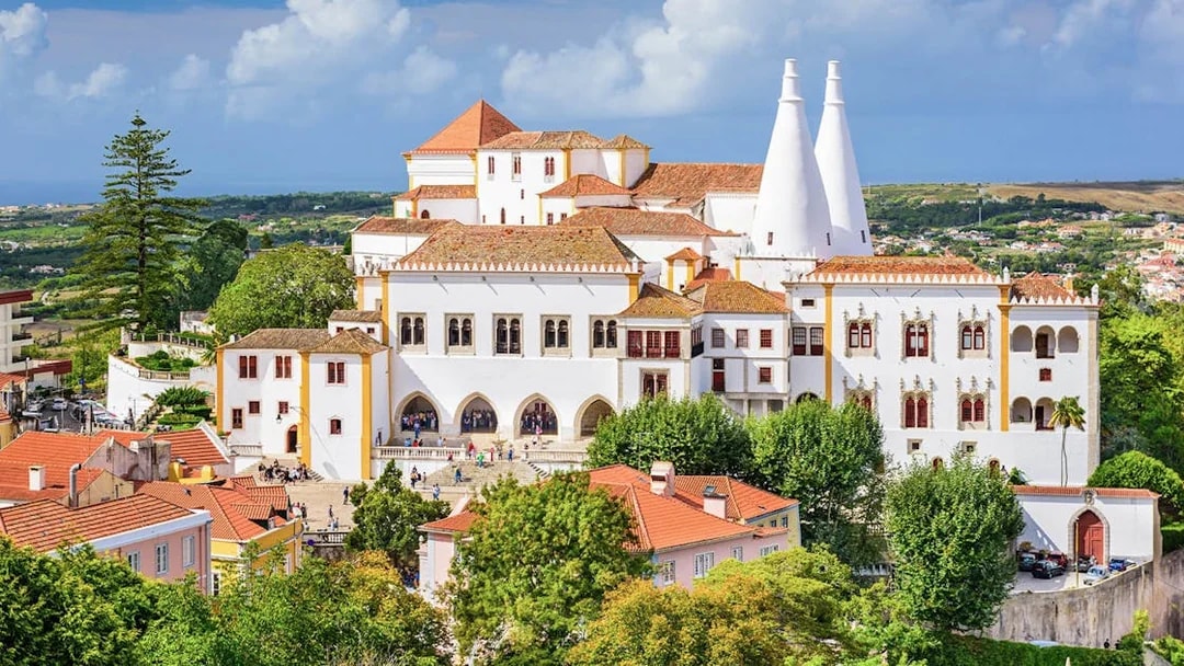 National Sintra Palace with iconic chimneys and surrounding gardens in Sintra, Portugal.