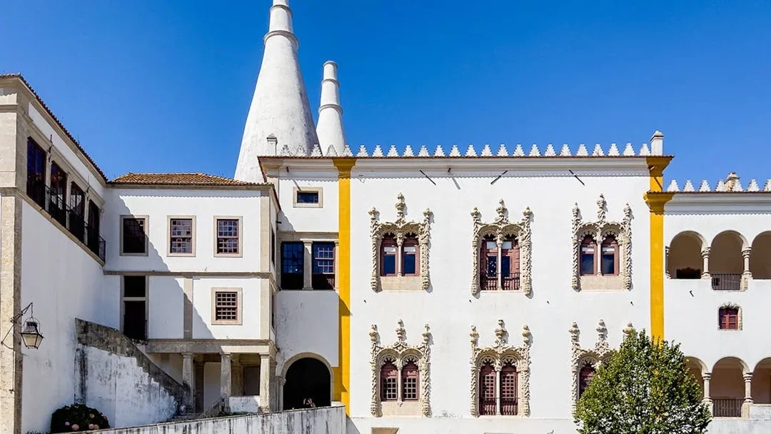 National Sintra Palace exterior with iconic chimneys and ornate windows in Sintra, Portugal.
