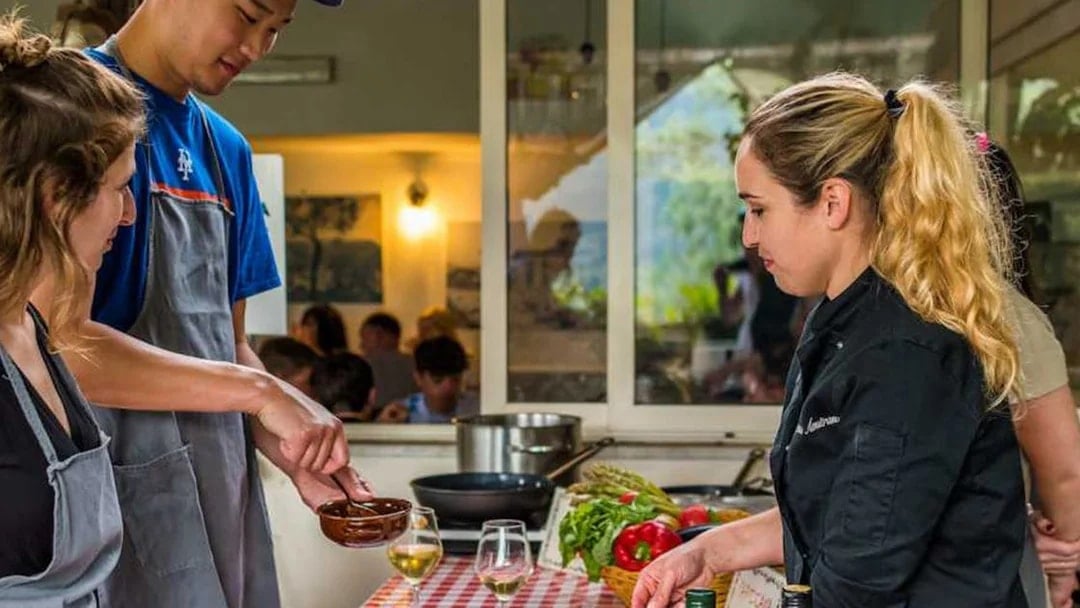 Participants cooking at a Neapolitan cooking school in Sorrento, Italy.