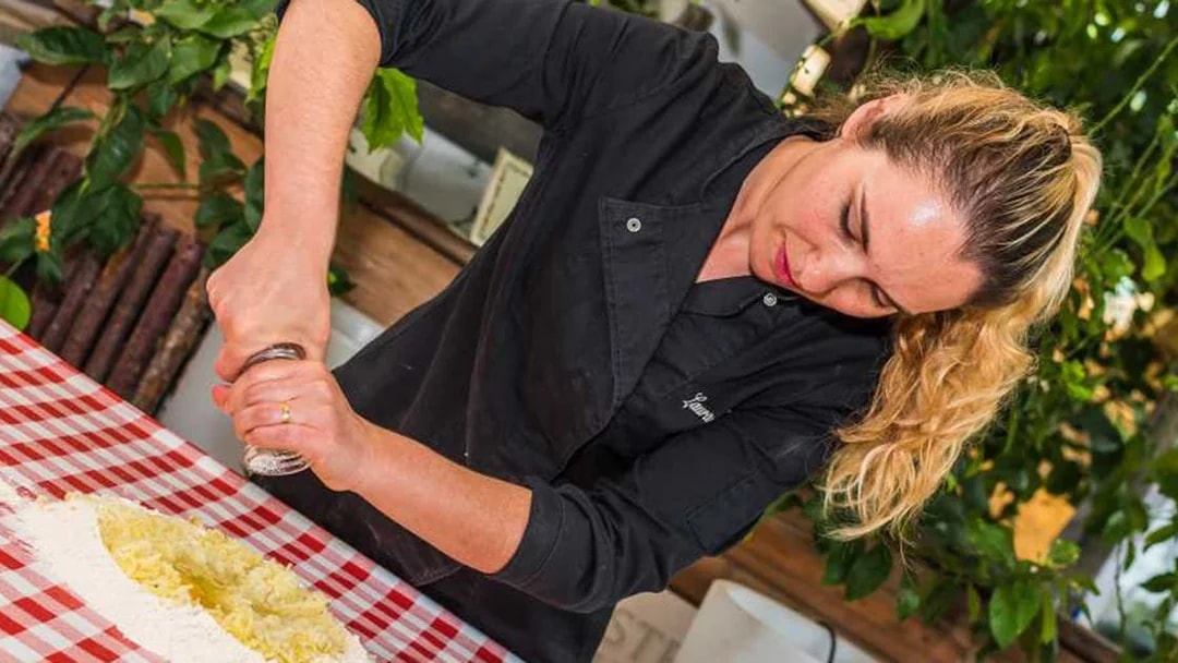 Woman preparing dough at Neapolitan cooking school in Sorrento.