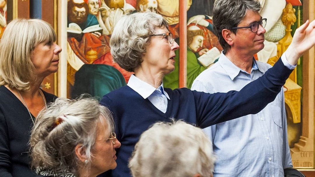 Group tour at Neues Museum viewing historical artwork.
