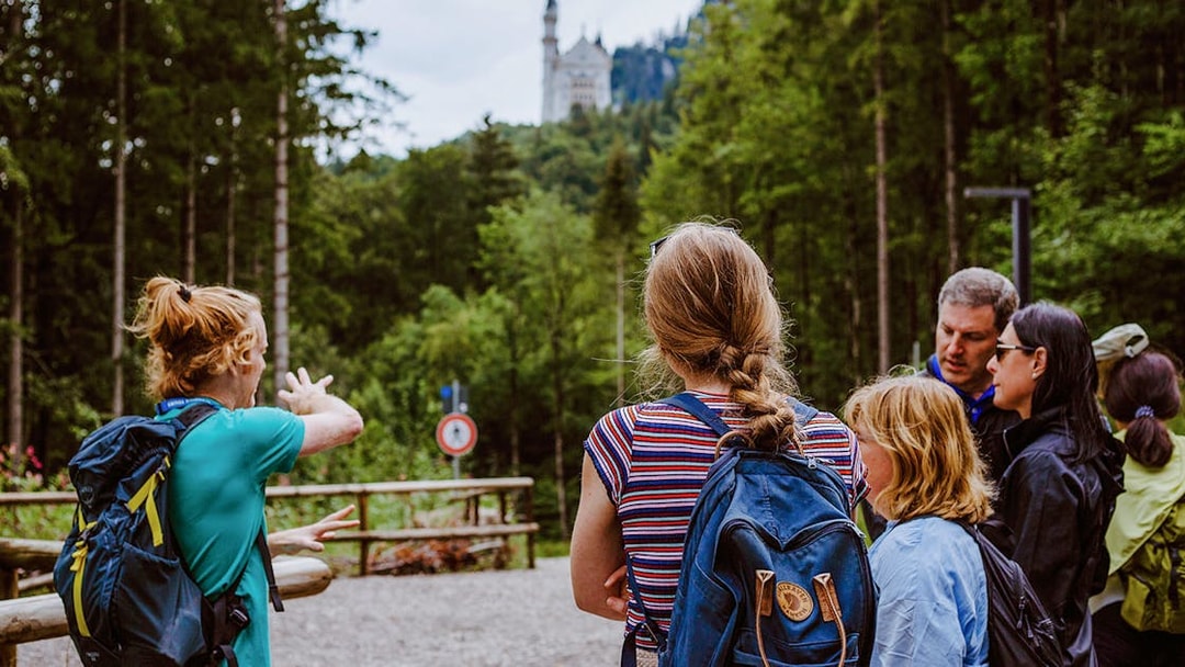 Tour group with guide near Neuschwanstein Castle in Germany.