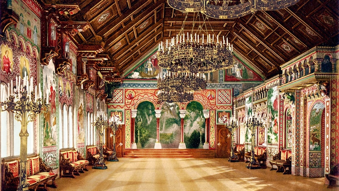 Neuschwanstein Castle interior with ornate chandeliers and detailed wall murals.