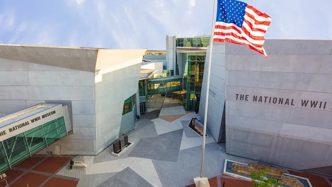 National WWII Museum entrance in New Orleans with American flag.