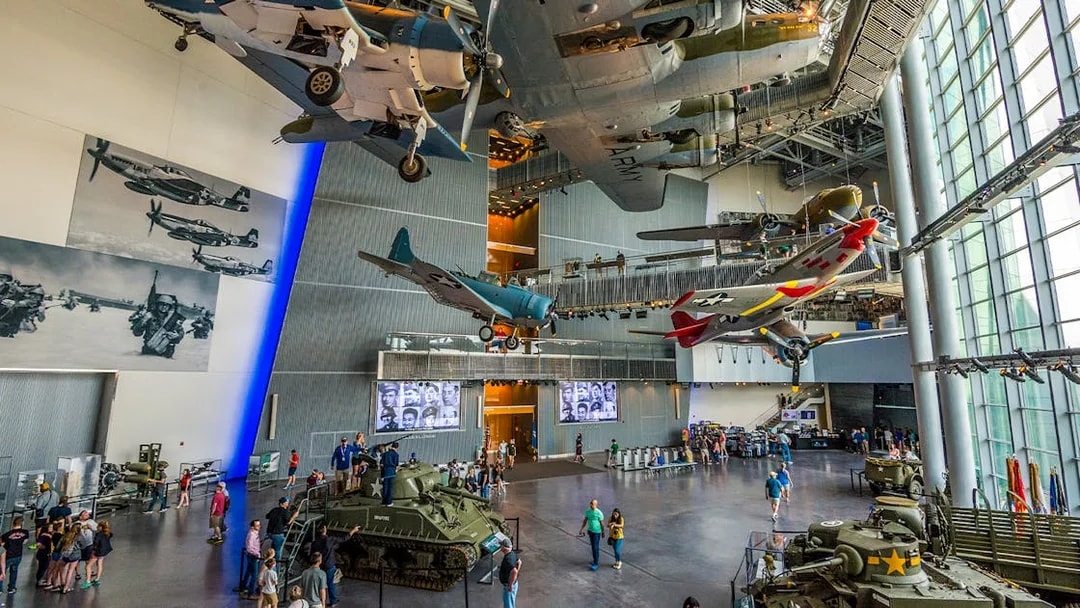 National WWII Museum in New Orleans with vintage aircraft and tanks on display.