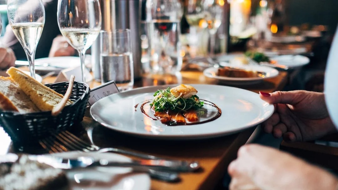 Dinner served on a Seine River cruise in Paris with wine and bread.