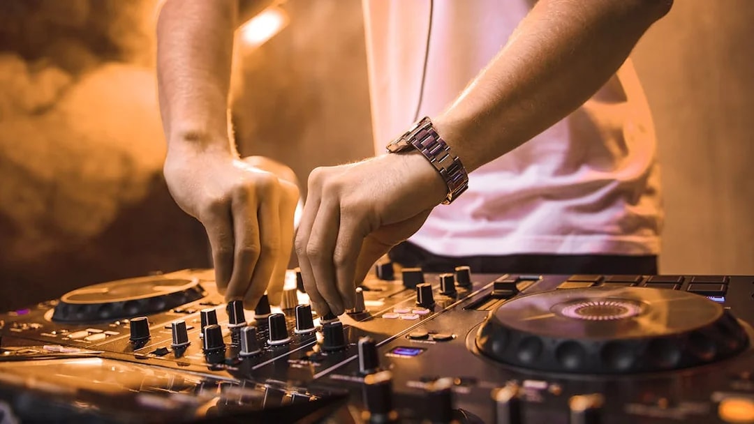 DJ mixing music on a cruise during New Year's Eve dinner event.