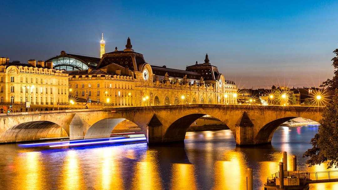 Musée d'Orsay and Eiffel Tower illuminated at night, Paris.