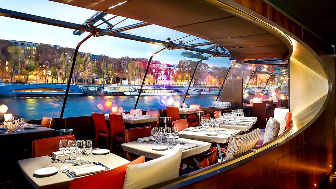 Bateaux Parisiens dining area with Seine River view, Paris New Year’s Eve 2025.